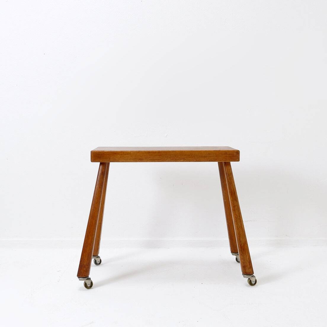 Vintage solid wood side table on casters