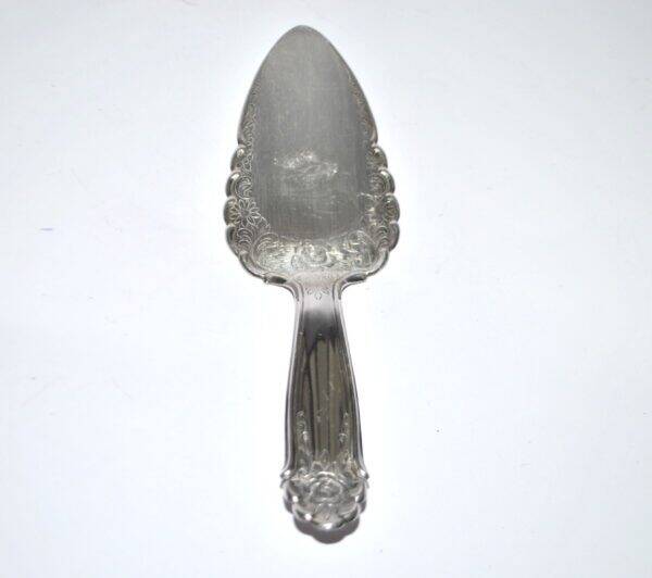 Vintage silver-plated pie server with rose decoration.