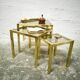 Trio of nesting tables in brass and smoked glass