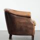 Club chair made of sheepskin leather finished with decorative nails