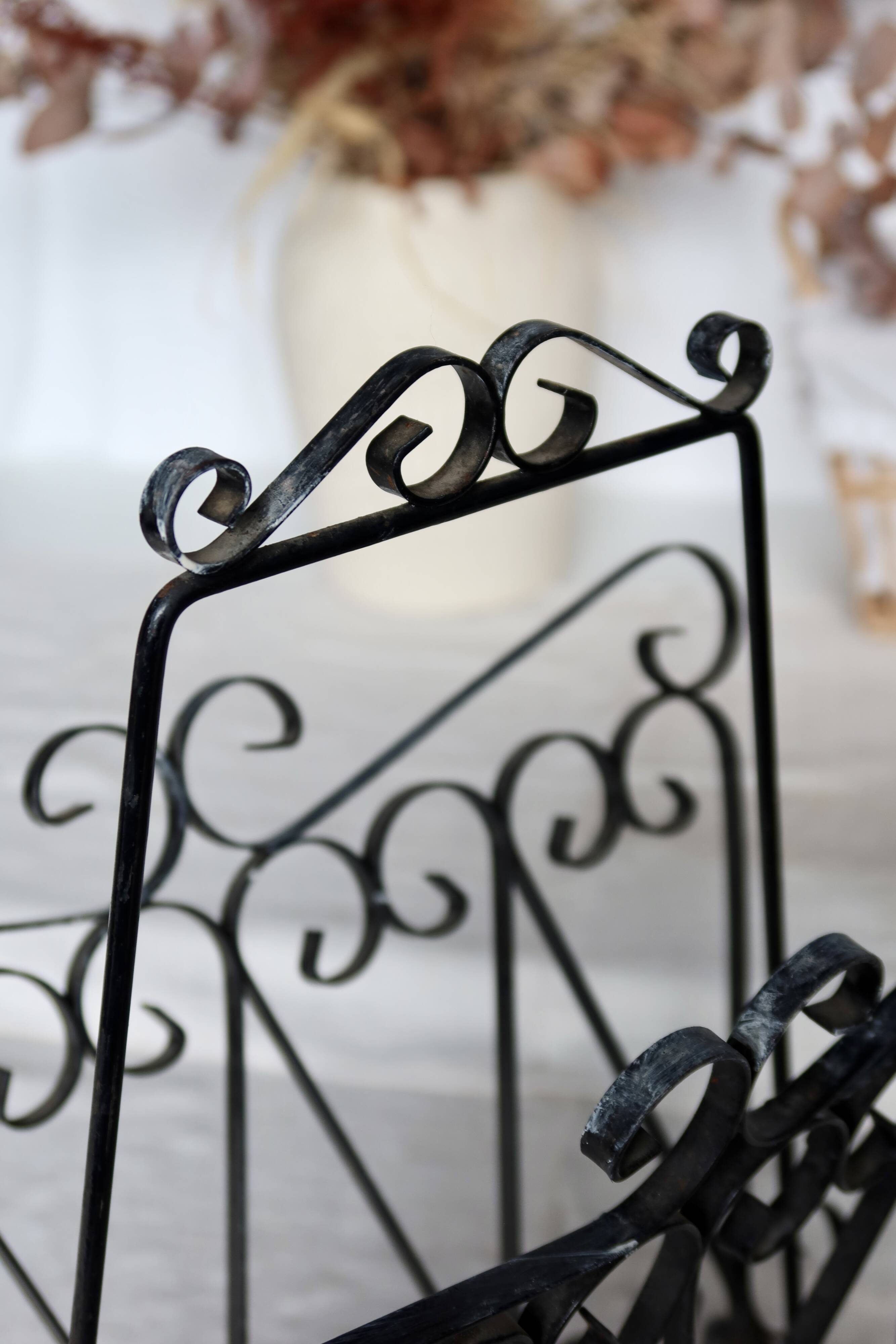 Vintage black metal scroll magazine rack