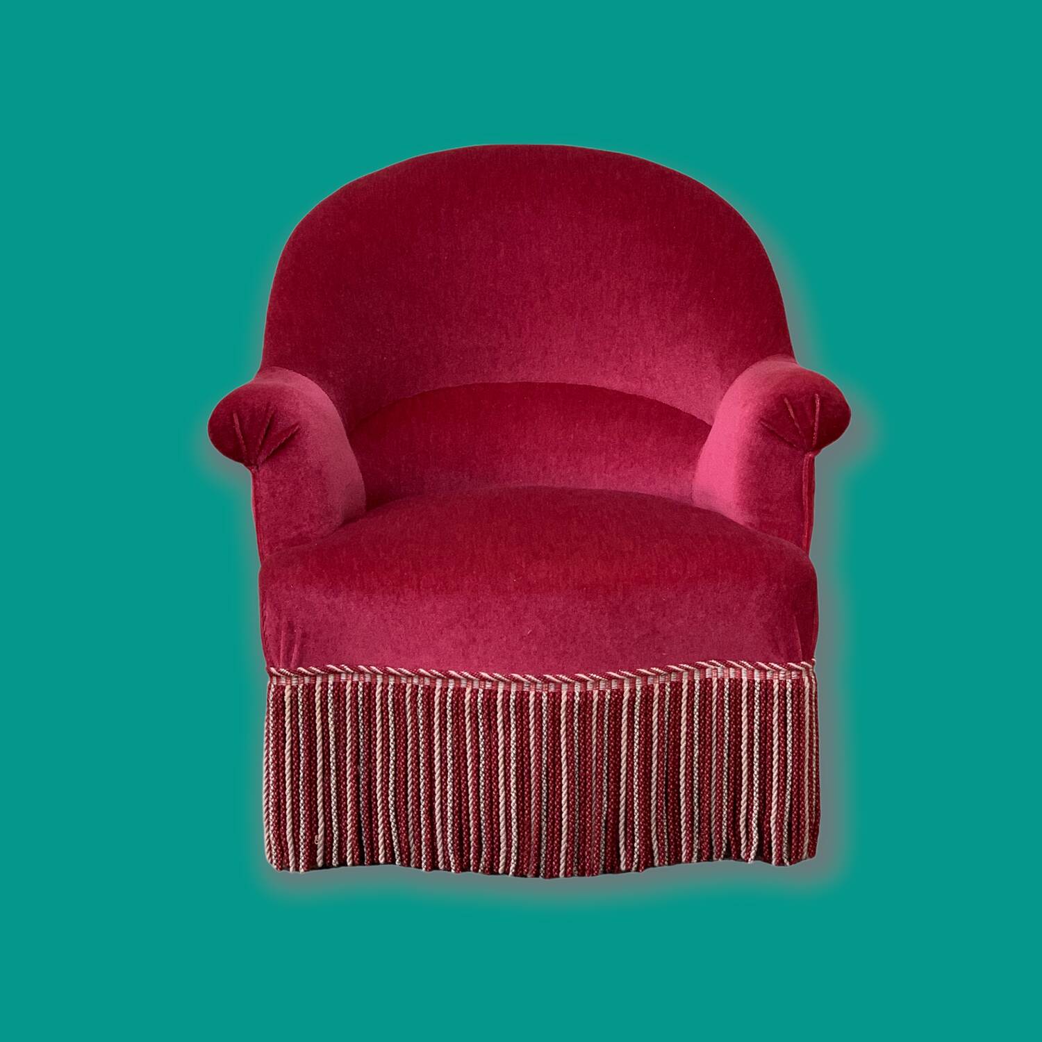 Old raspberry velvet toad armchair