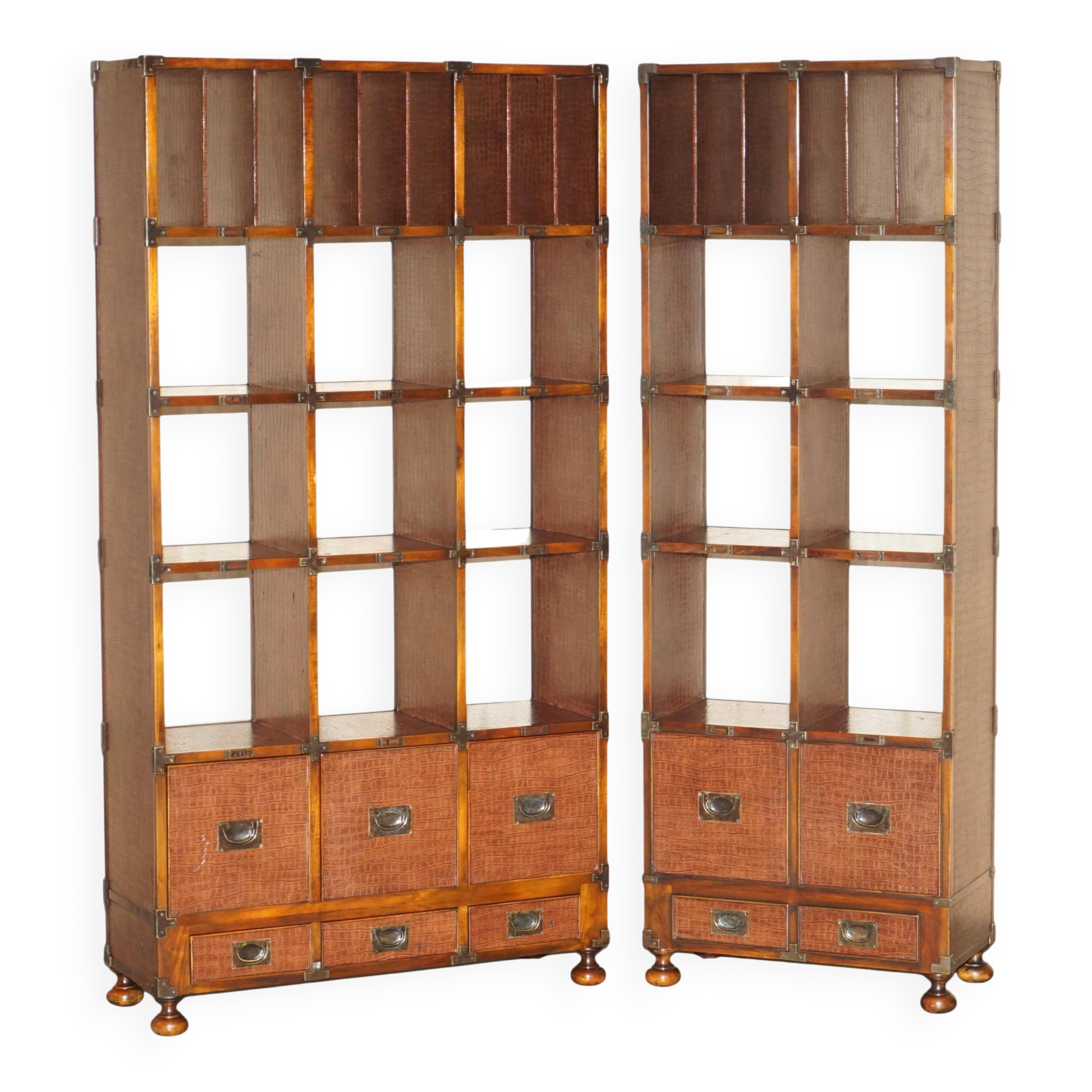 Pair of open bookshelves in crocodile leather with drawers and compartments.