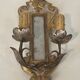 Pair of wall sconces in carved wood and silvered and gilded patinated metal with a central mirror.