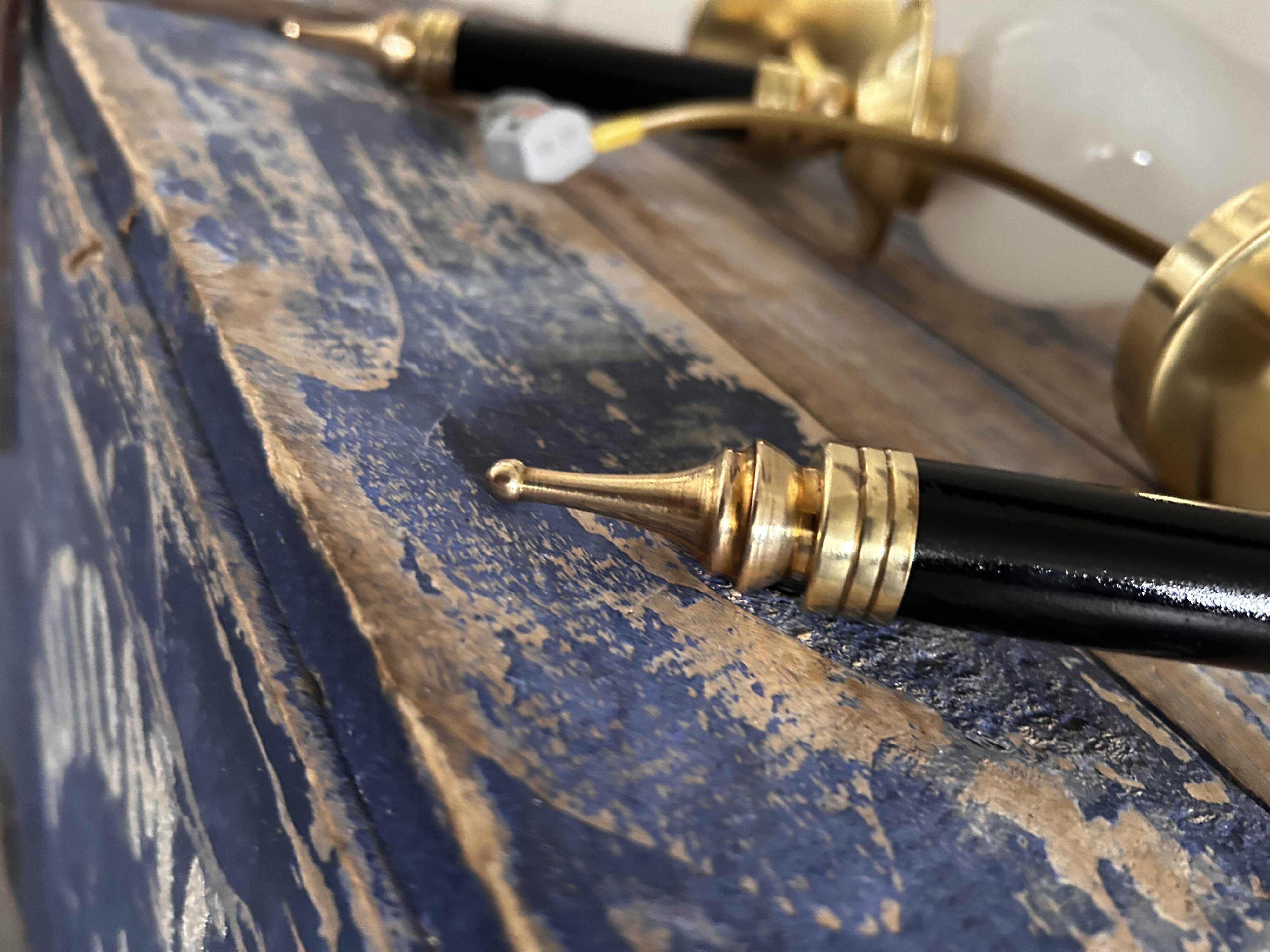 Pair of brass and black torchiere wall lights