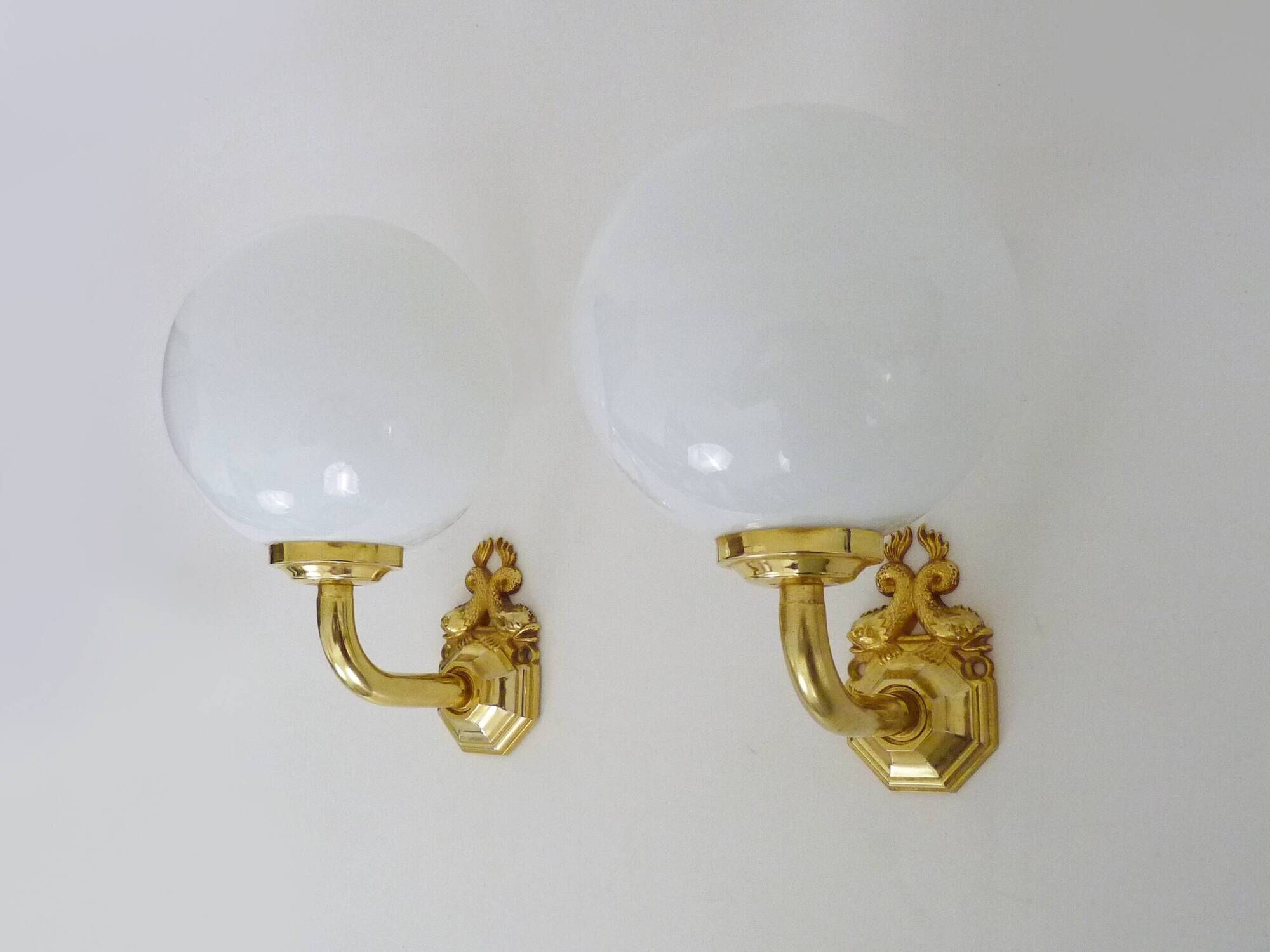 Pair of wall sconces with carp fish, brass and opaline globe.