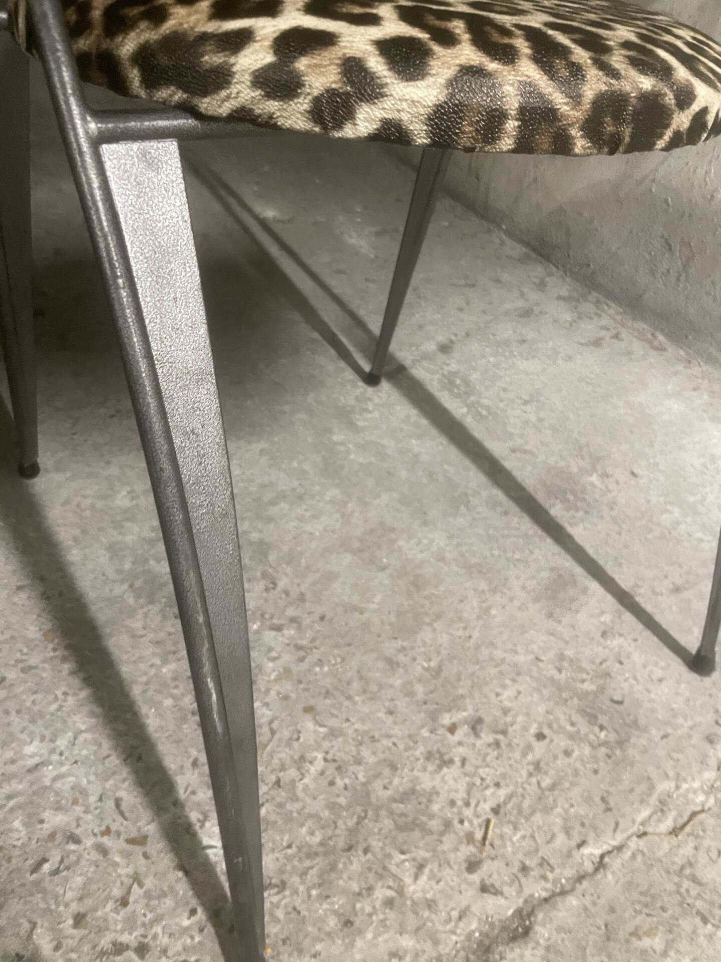 Pair of folding chairs from the 80s with leopard print seats.