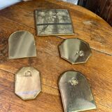 Set of five small wall mirrors in brass.