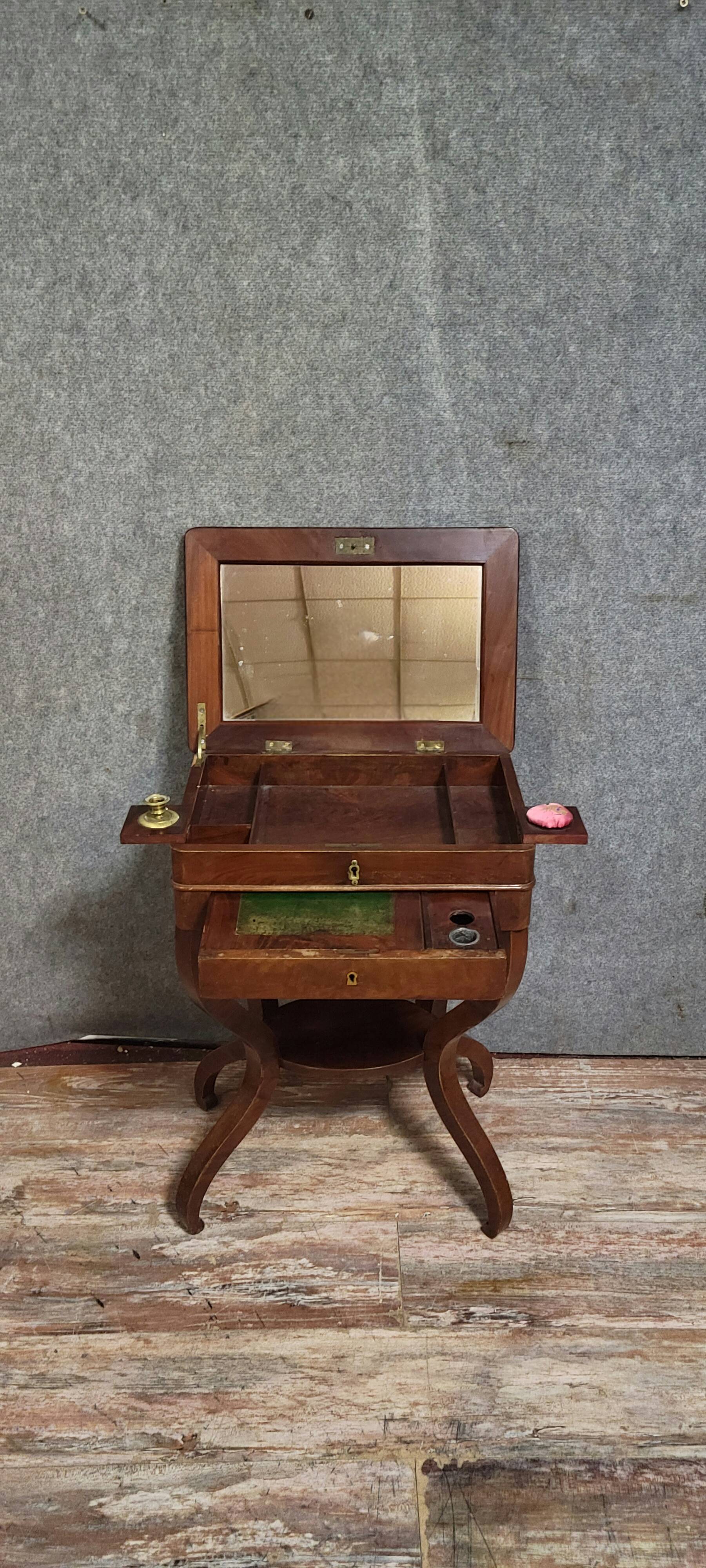 Empire writing table, in mahogany, resting on curved legs.