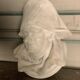 Marble sculpture, man's head in a hat.