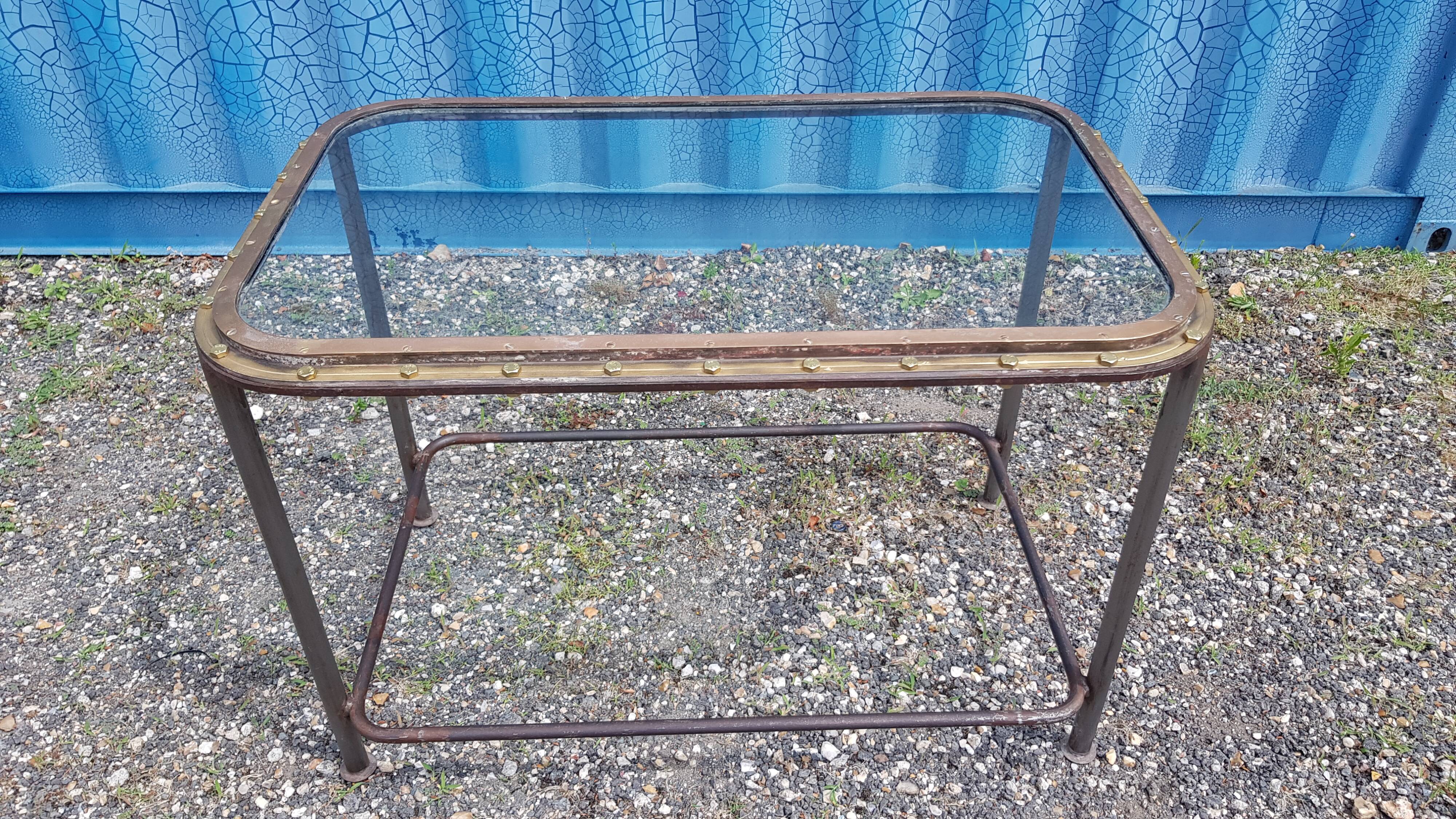 Table with an old ship porthole in brass and a metal base / 110 x 70 x 76 cm