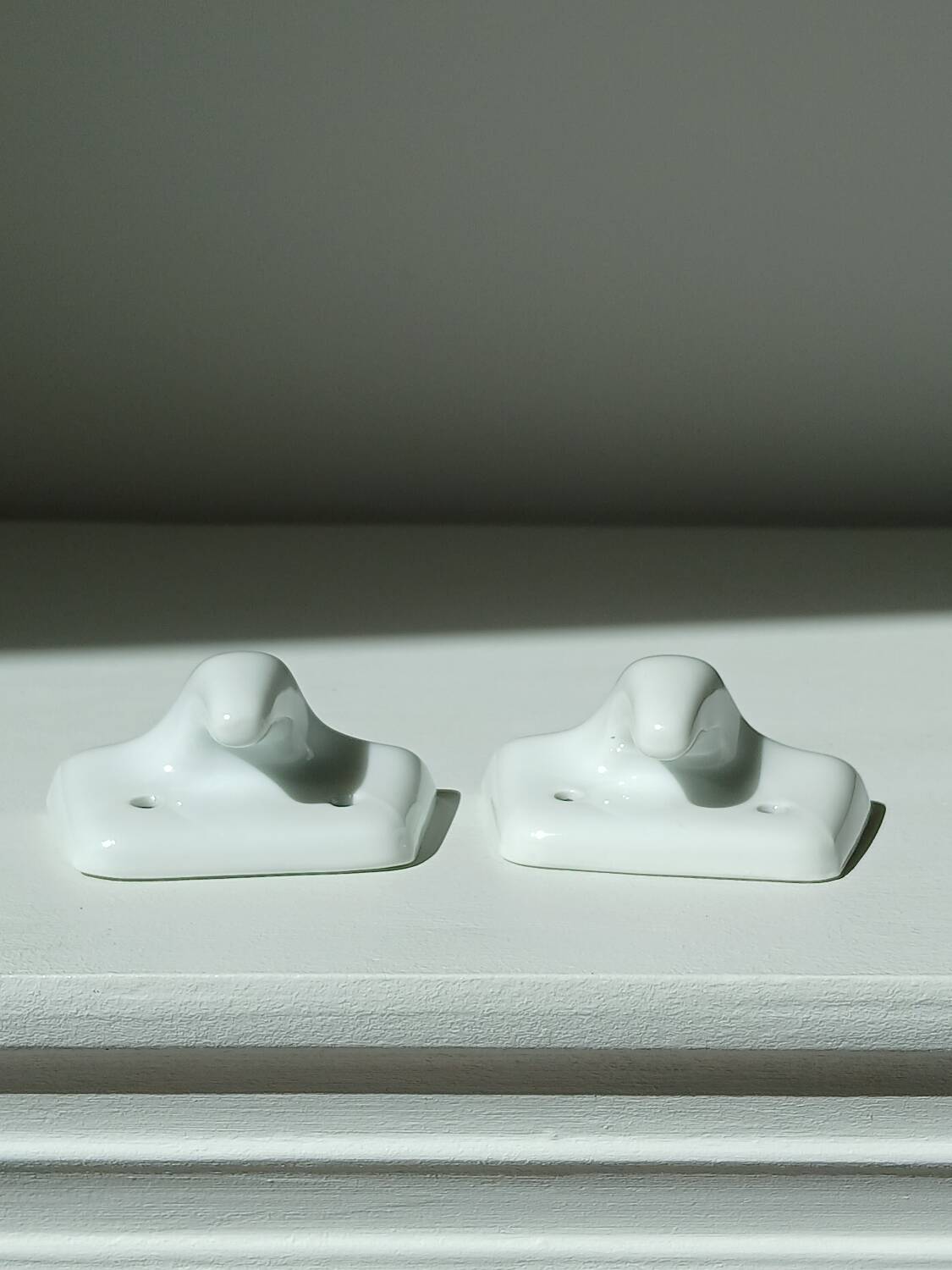 Set of two porcelain tea towel holders