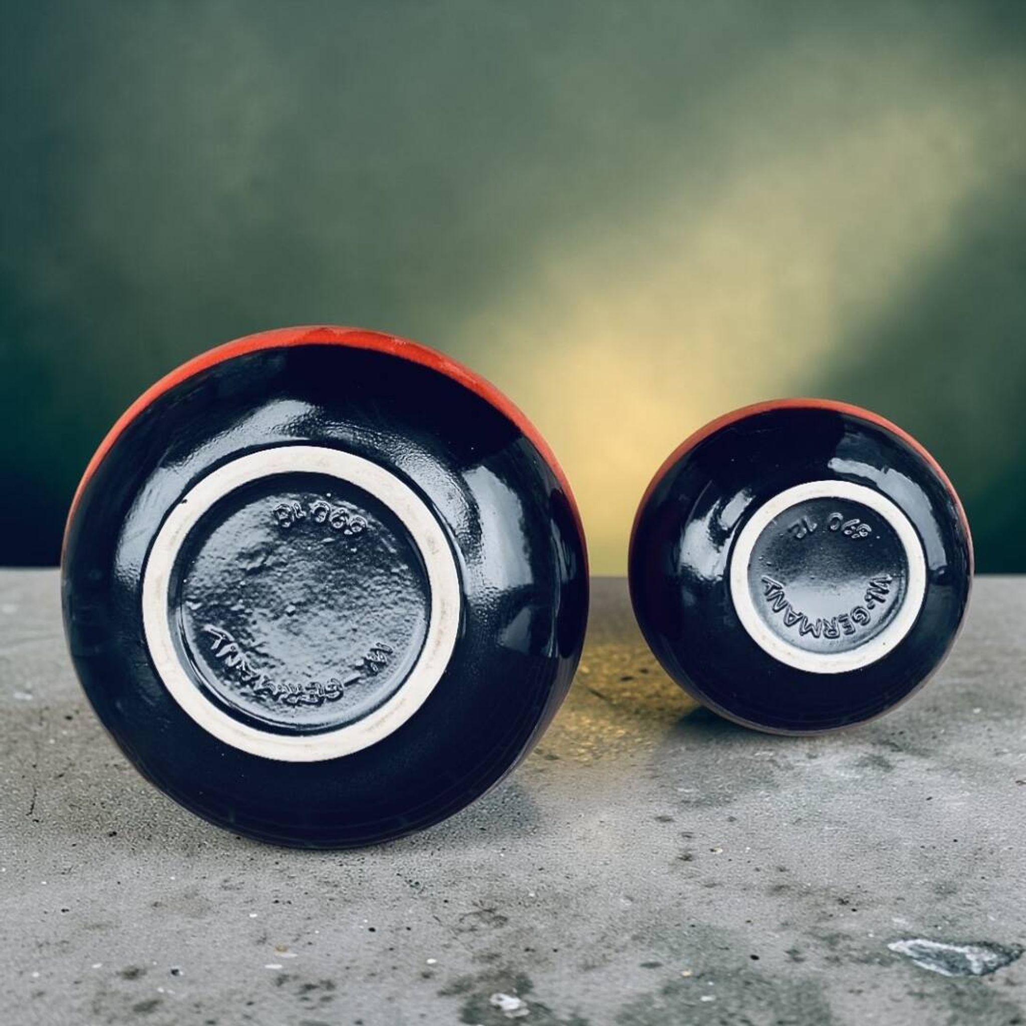A pair of black and red spherical vases by Bay Keramik, West Germany, from the 1960s.
