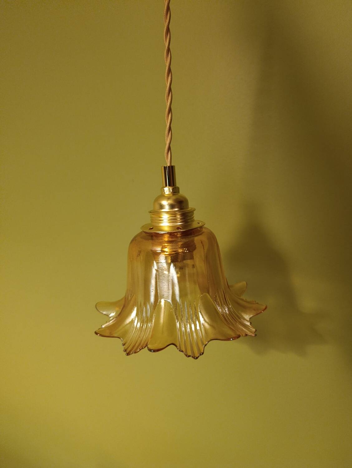 Amber tulip glass portable lamp, golden braided cord.