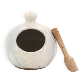 White ceramic salt pot and wooden spoon