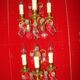 Pair of bronze and crystal wall lights with three candle holders from the early 20th century.