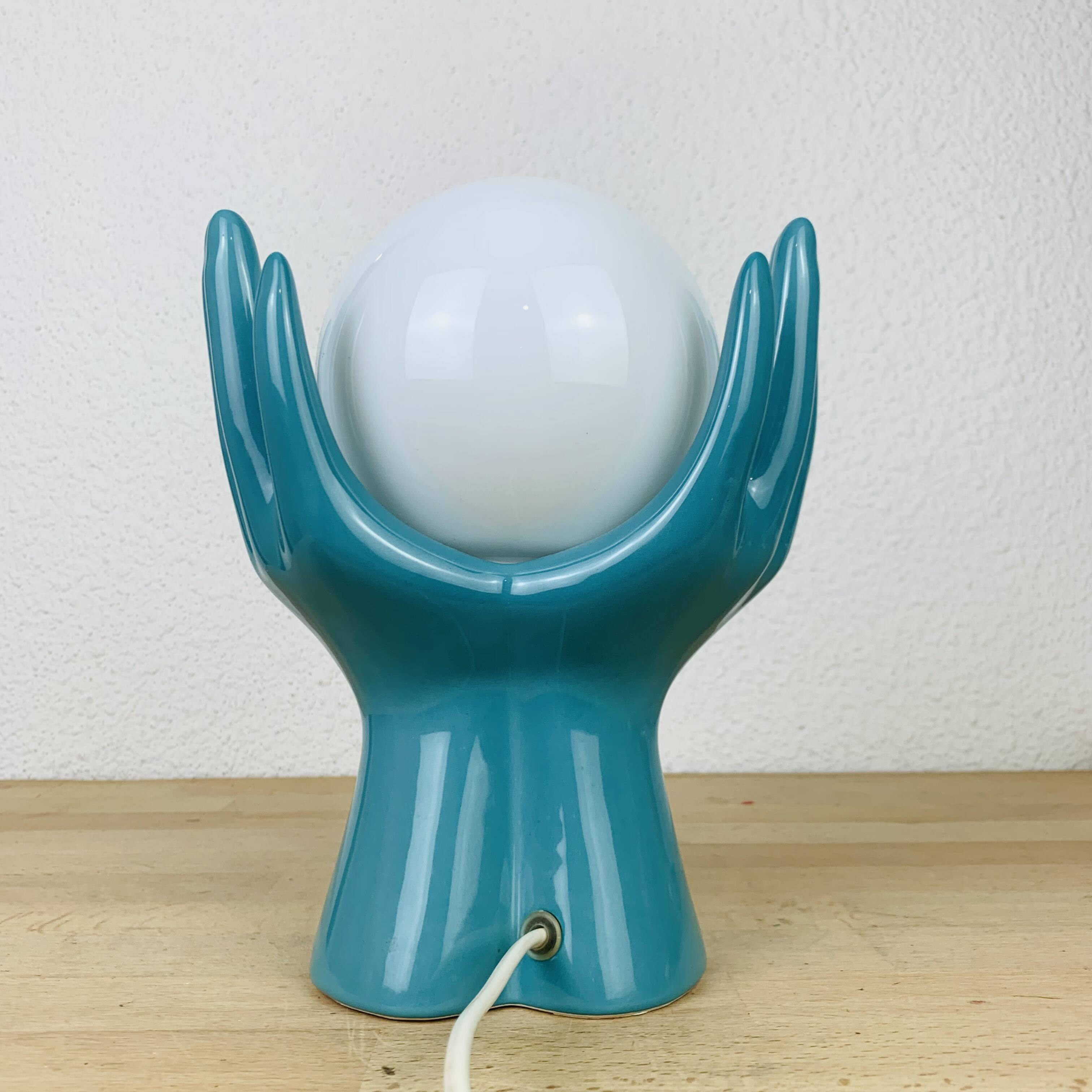 Blue ceramic hands lamp and glass globe