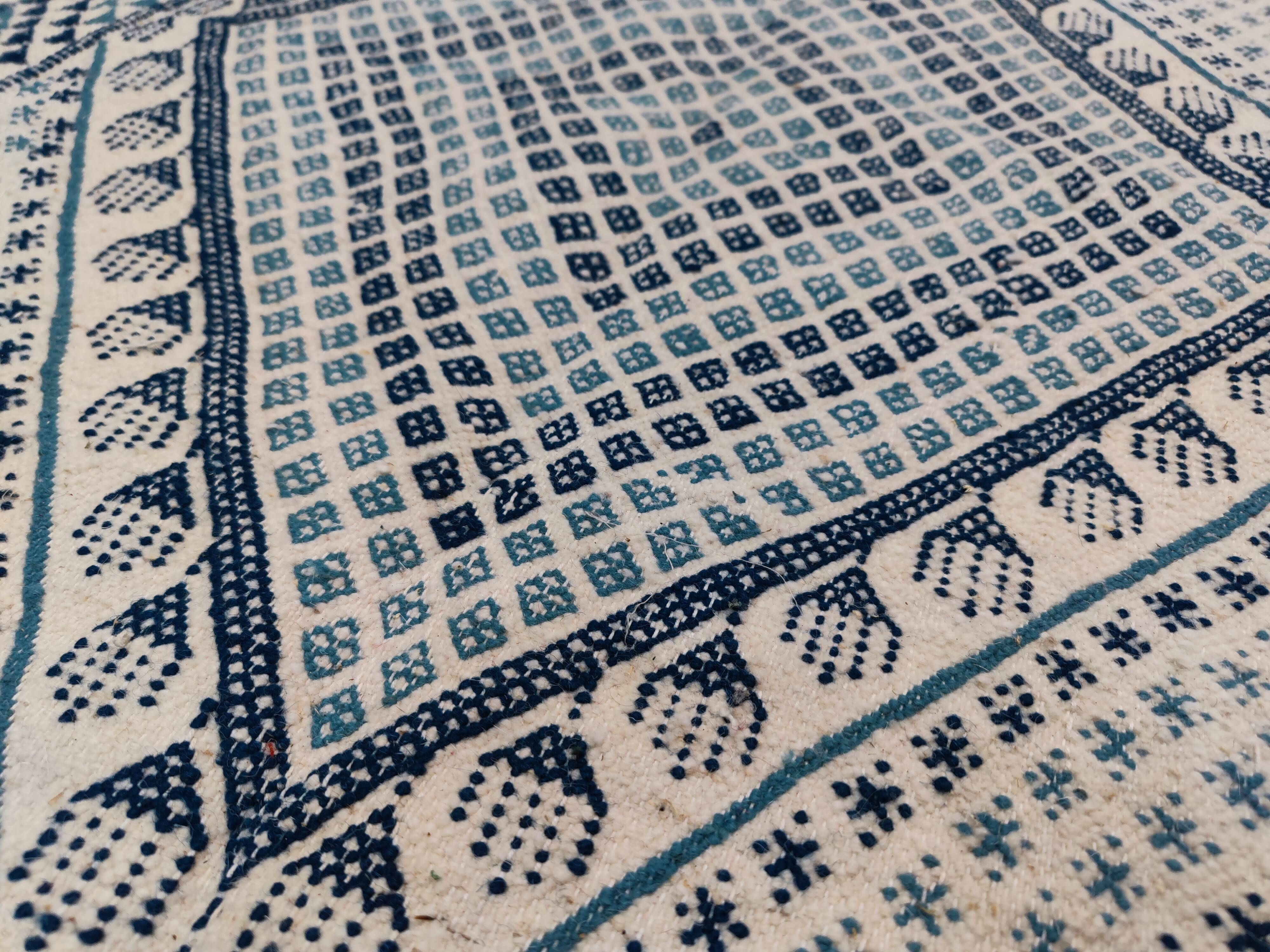 White and blue handwoven rug in natural wool