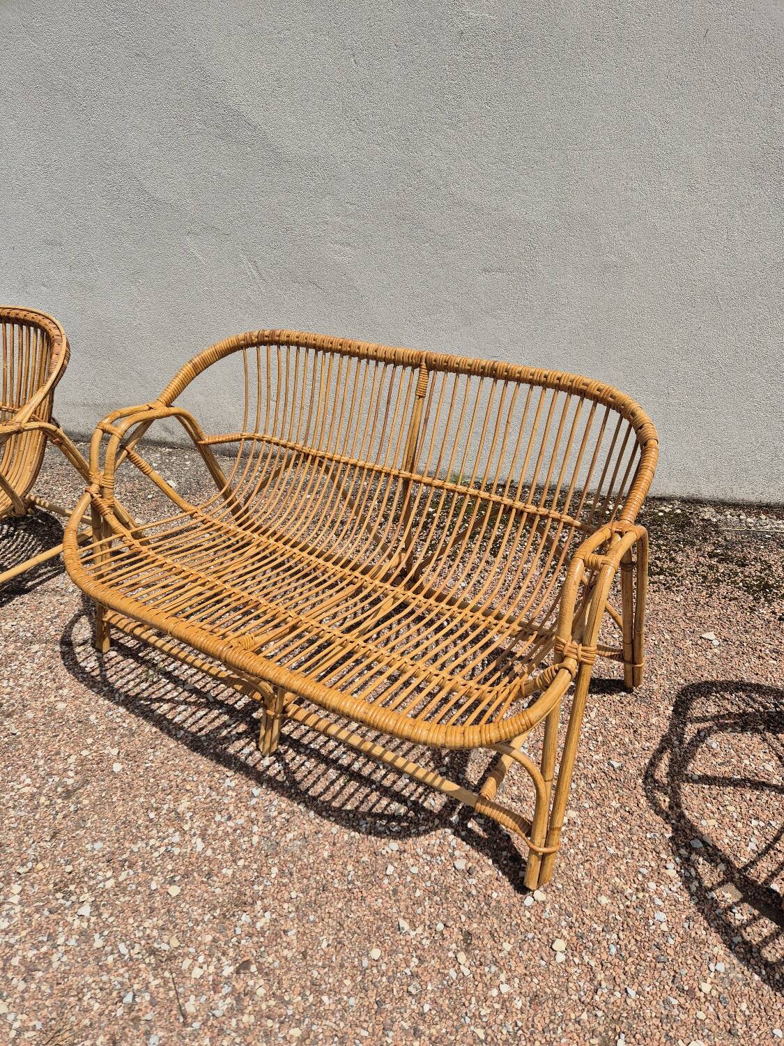 Rattan lounge with two armchairs and a vintage 1950s bench.