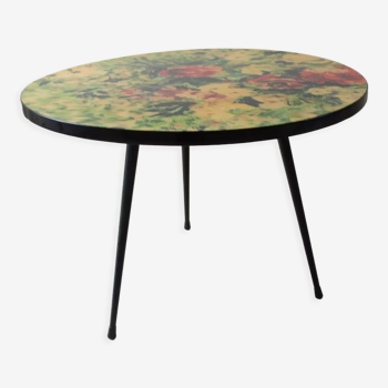 Round coffee table above resin flower decoration