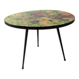 Round coffee table above resin flower decoration
