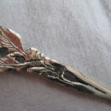 silver metal sugar and silver sugar spoon.