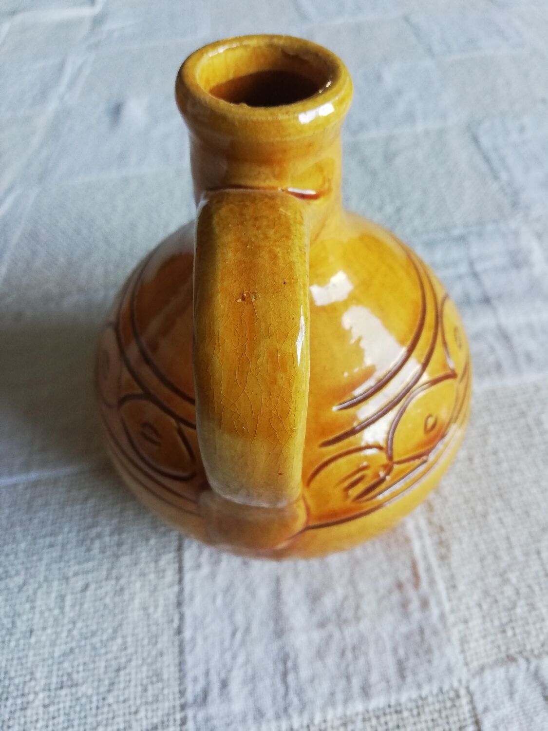 Round ochre glazed jug with handle