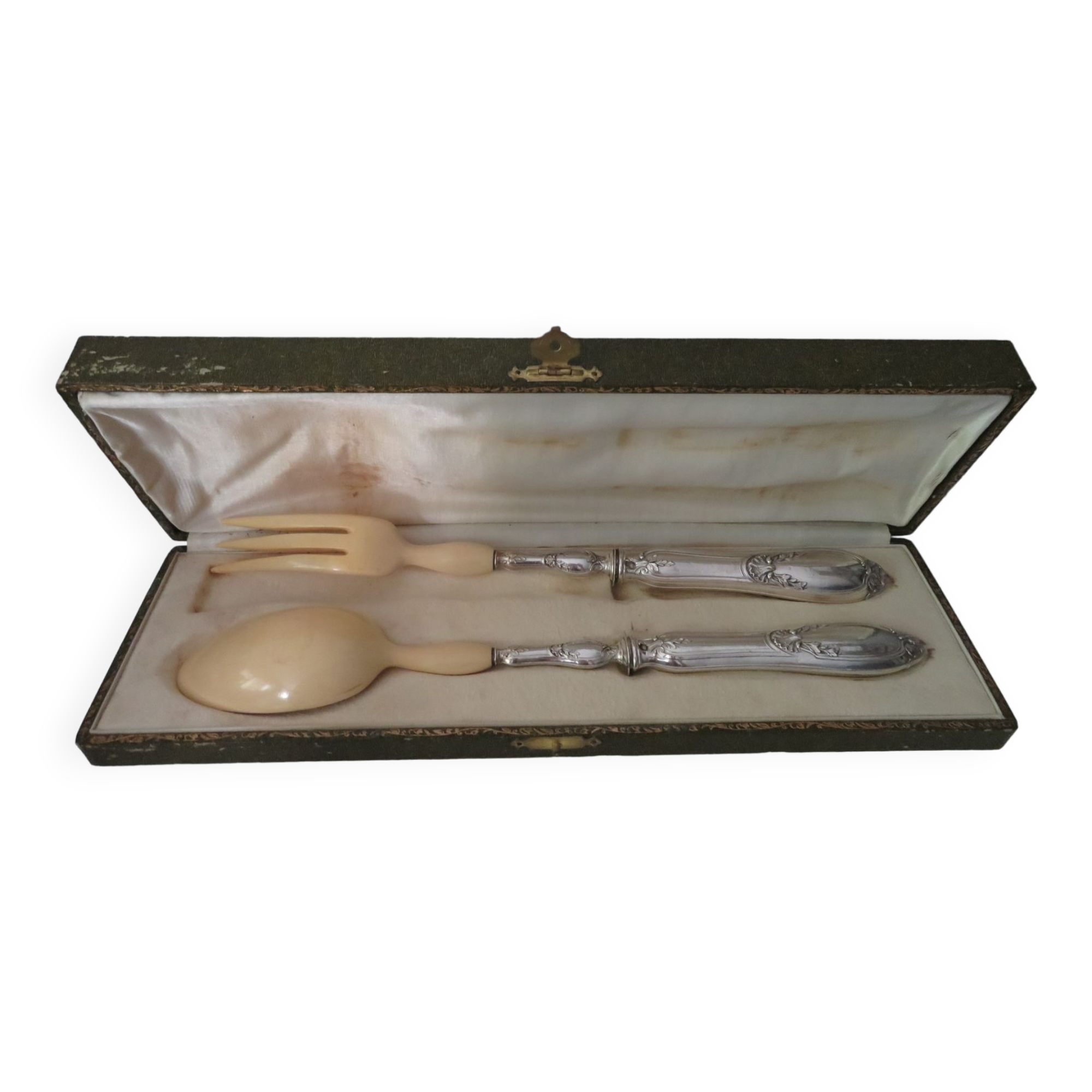 Silver salad servers stuffed in its case