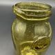 Yellow bubbled glass apothecary jar with cork lid.