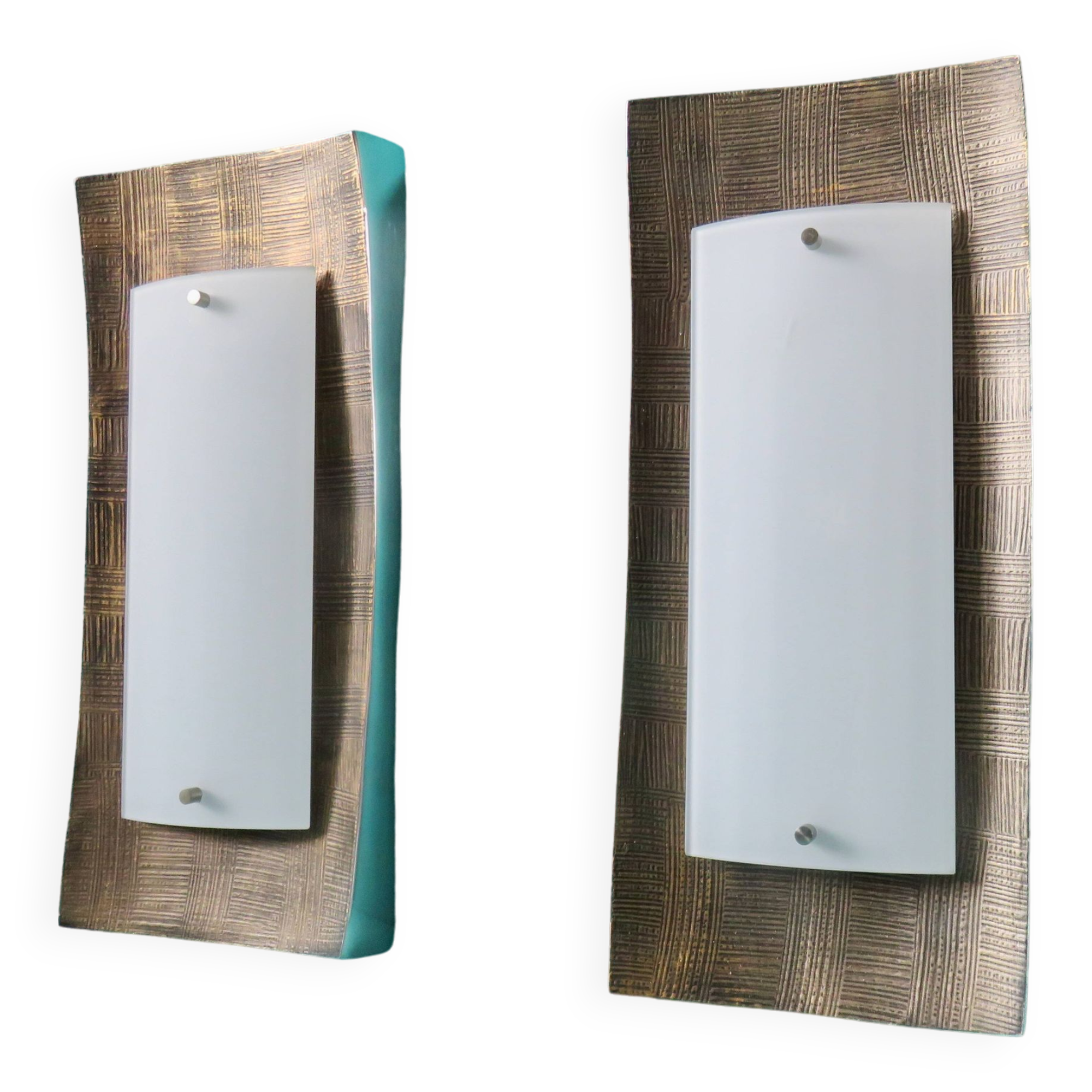 Pair of wall sconces in gold-plated alloy with bas-relief and opaline glass. Germany, 1980