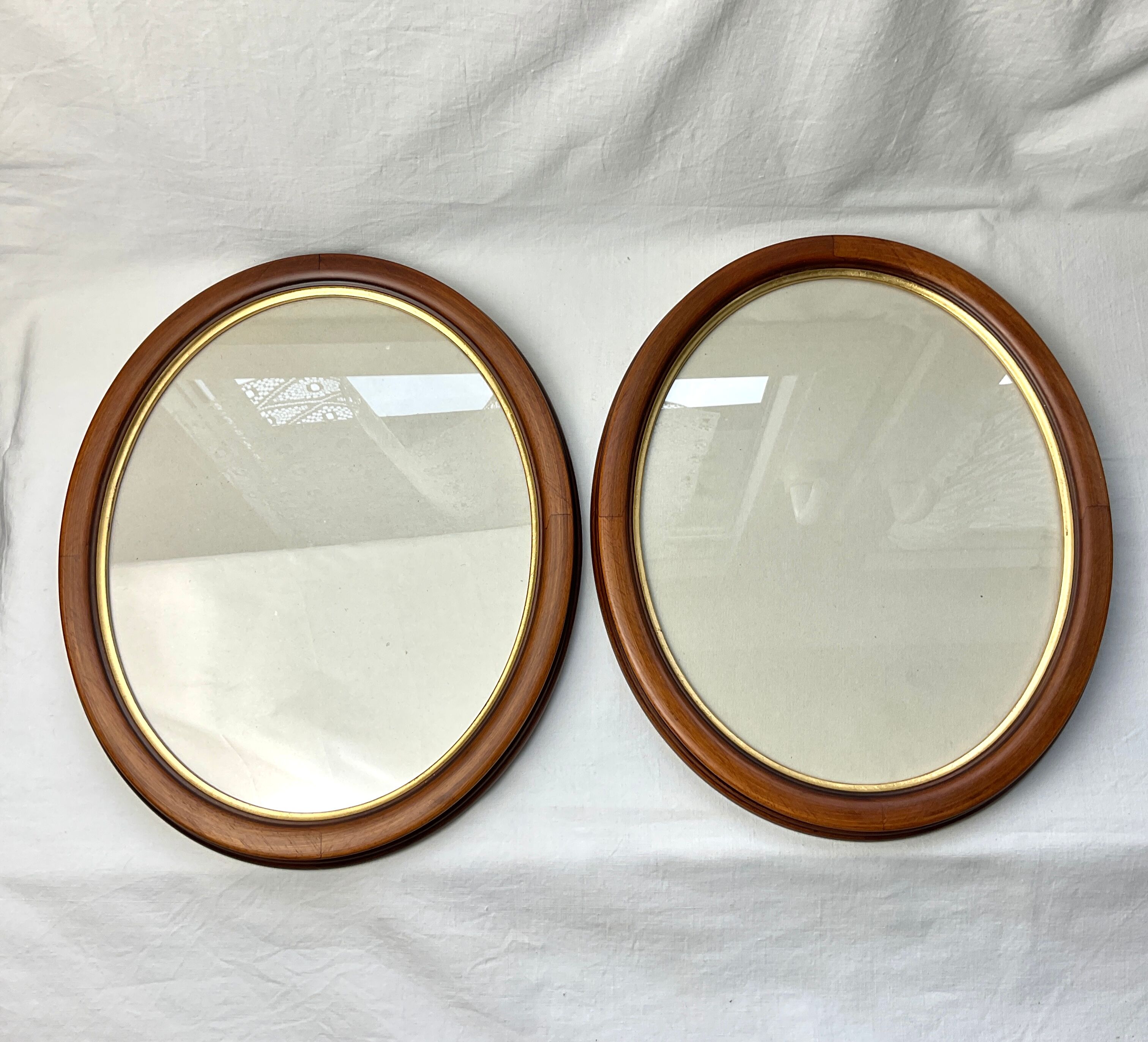 Pair of oval wooden frames with gilding