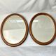 Pair of oval wooden frames with gilding