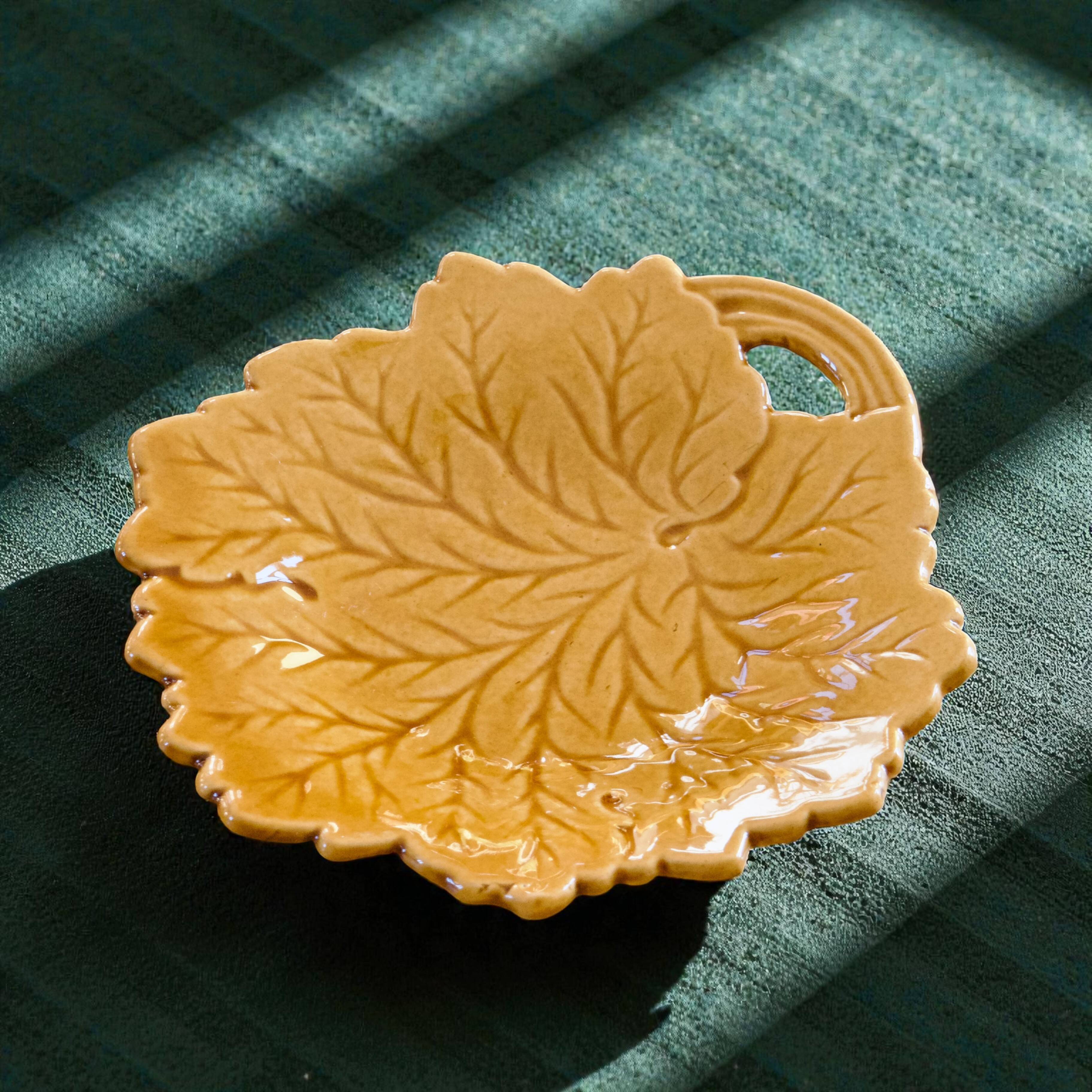Vintage soap dish in ochre faience, leaf shape.