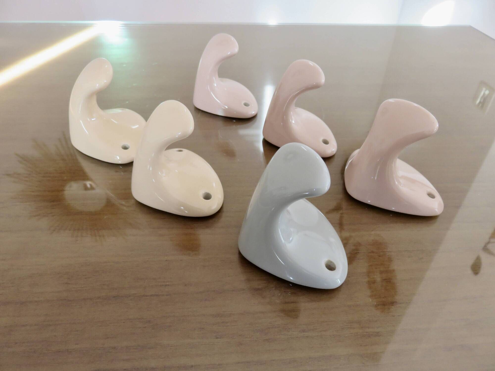 Pair of salmon-colored art deco porcelain hooks from the 30s and 40s