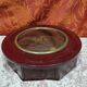 Small round bull's eye wall display case in wood and curved glass