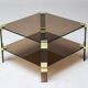 Hollywood Regency coffee table in brass and smoked glass, chic two-tier coffee table.