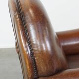 Sheep leather armchair on wheels