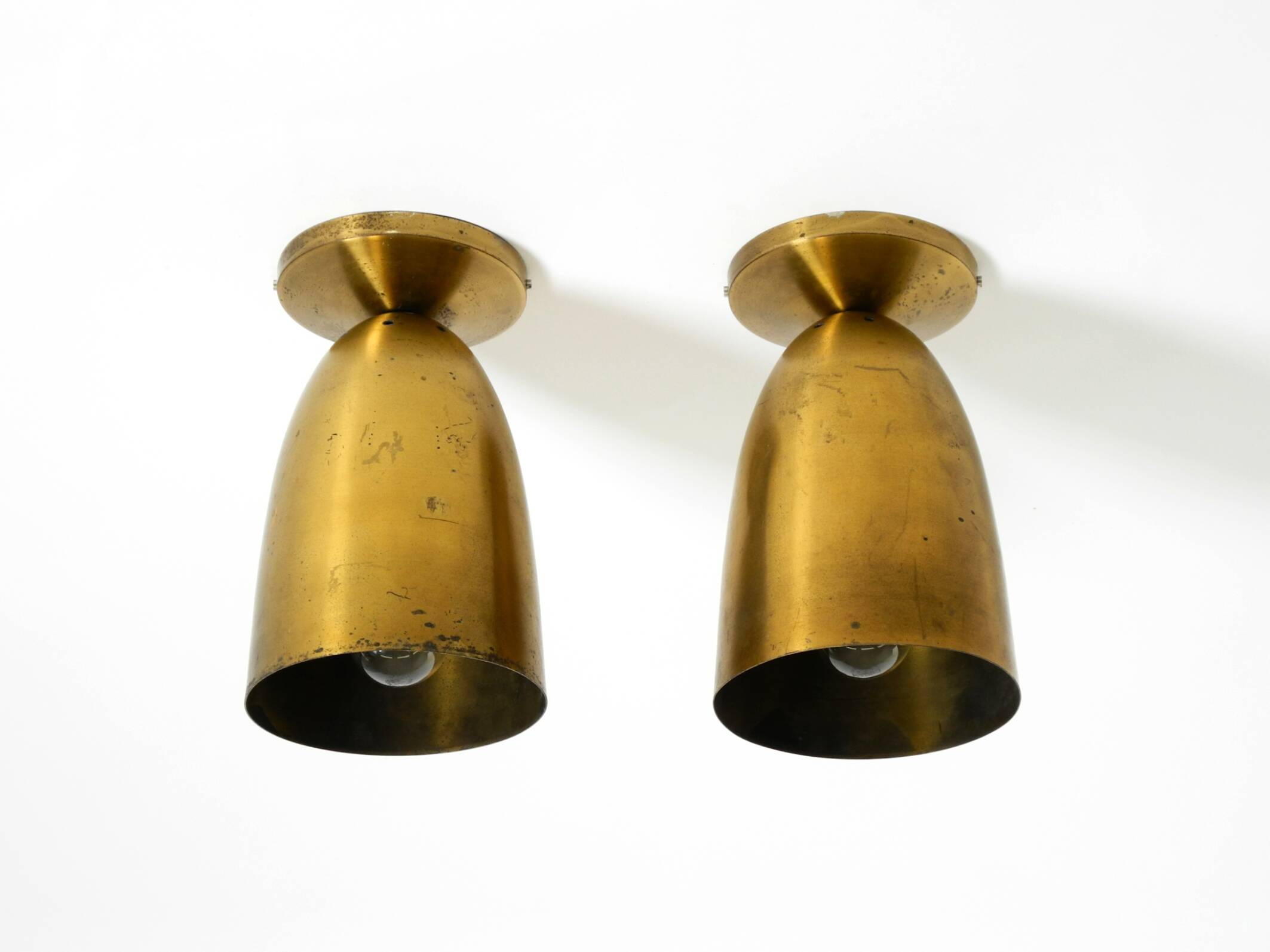A pair of large, original Mid Century Modern brass ceiling lamps