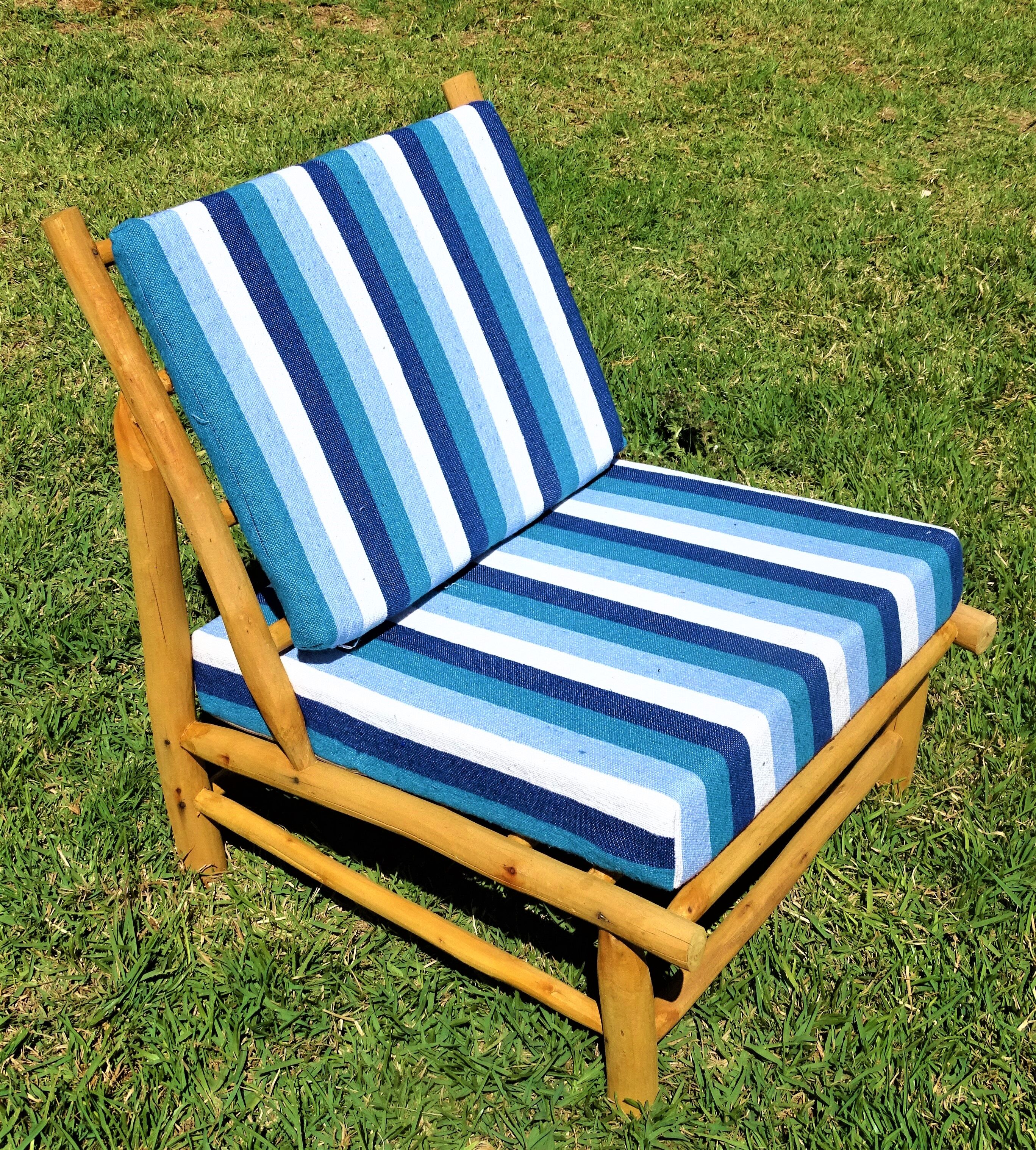 Low armchair in eucalyptus wood with blue and white cushions