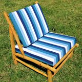 Low armchair in eucalyptus wood with blue and white cushions