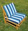 Low armchair in eucalyptus wood with blue and white cushions
