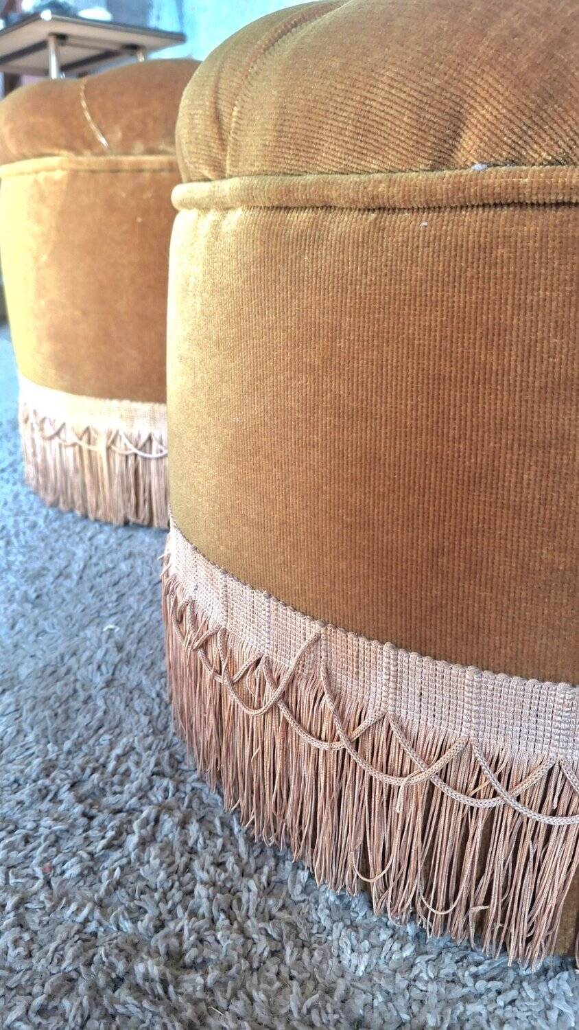 False pair of round Napoleon III poufs in ochre velvet, tufted with fringes.