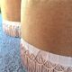 False pair of round Napoleon III poufs in ochre velvet, tufted with fringes.