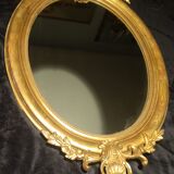 Ovoid mirror with double pediments gilded with leaf circa 1830, 105x66 cm