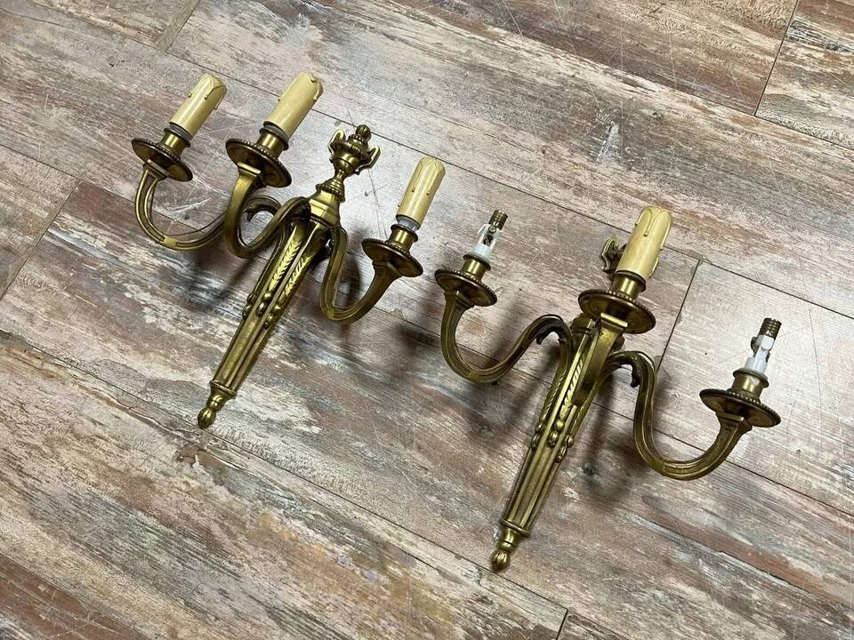 Pair of Louis XVI style gilt bronze wall lights with two light arms, 20th century