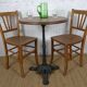 oak tray table with cast iron legs and pair of bistro chairs