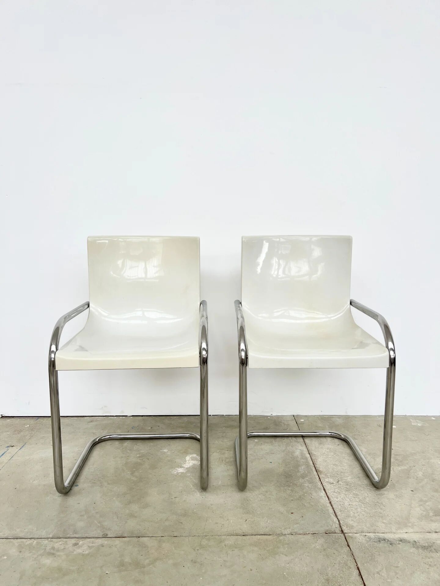 Pair of white moulded shell chairs with chrome tube — Space Age 70s