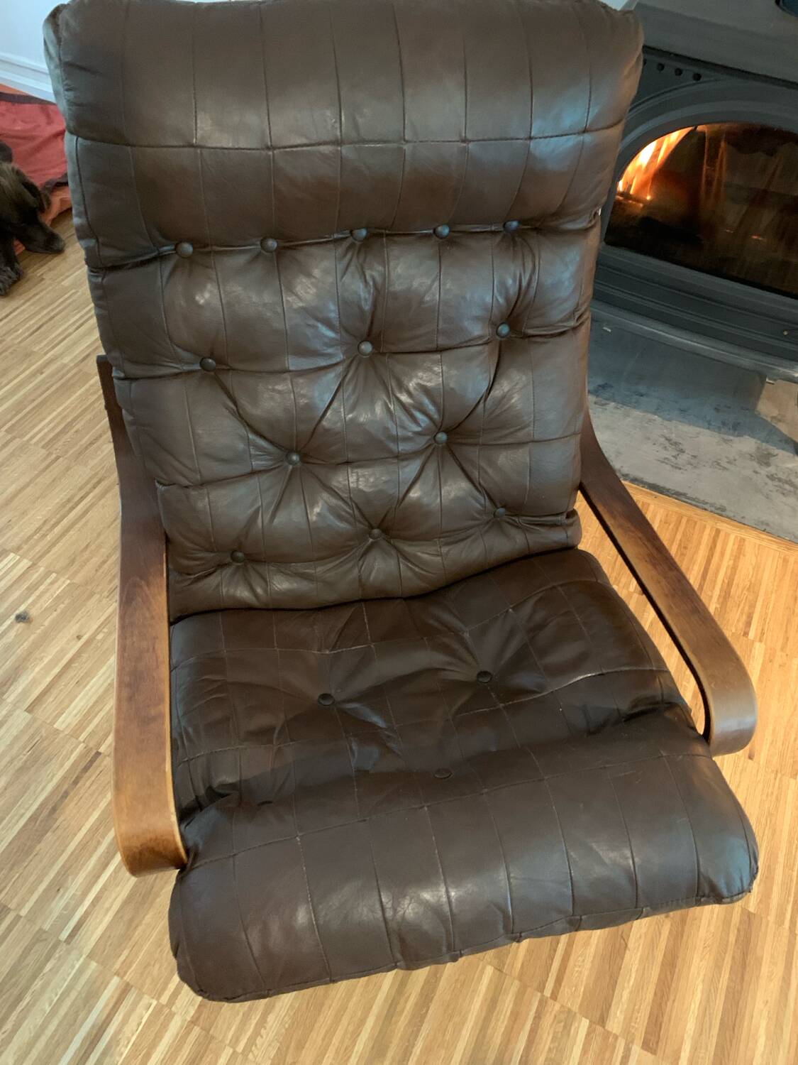 Vintage leather armchair with wooden armrests