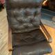 Vintage leather armchair with wooden armrests