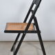 Folding chair seated in cannage